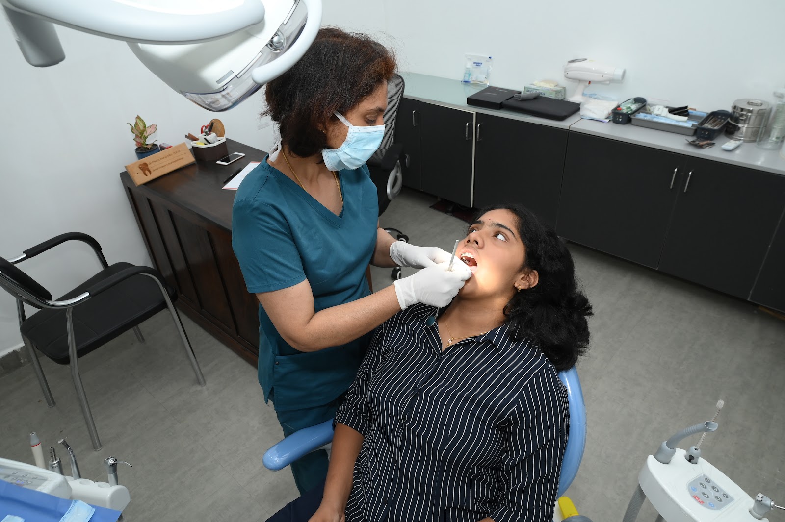 Dr. Preeti treating a patient in dental chair